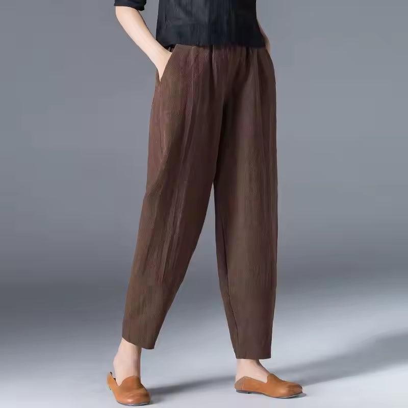 Breathable women’s trousers displayed on a plain background for warm weather styling.