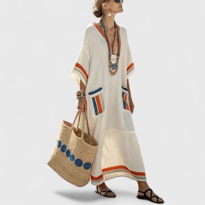Casual striped dress displayed on a plain background with relaxed fit and boho-inspired trim.