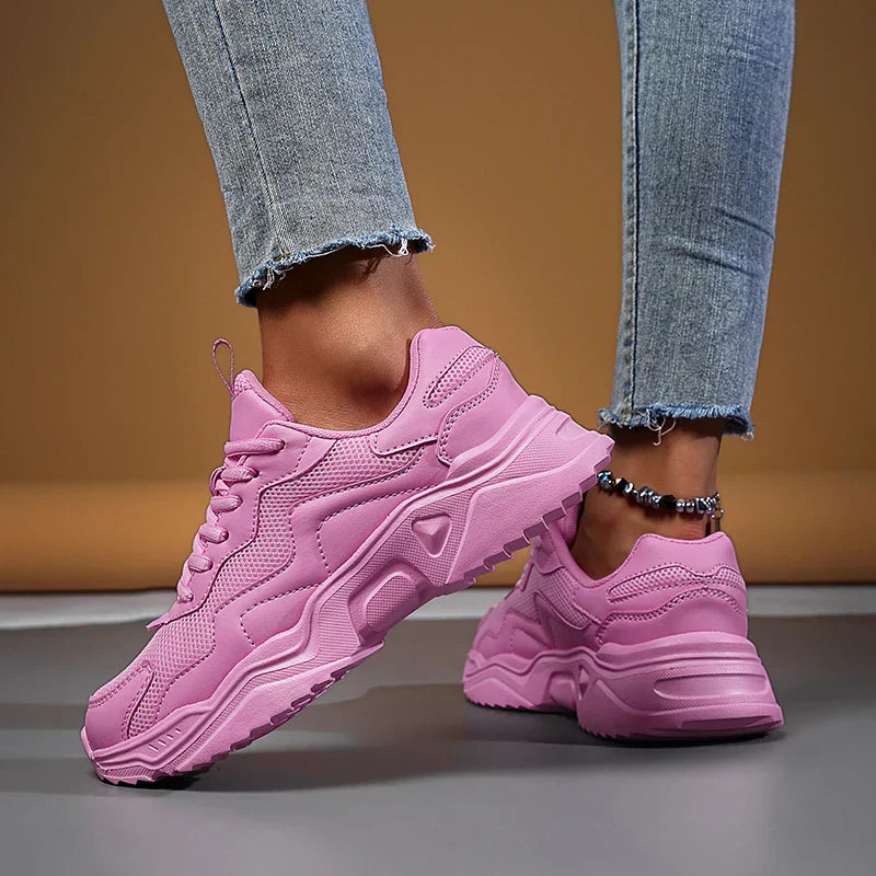 Women’s casual sneakers with mesh upper displayed on a clean plain background.