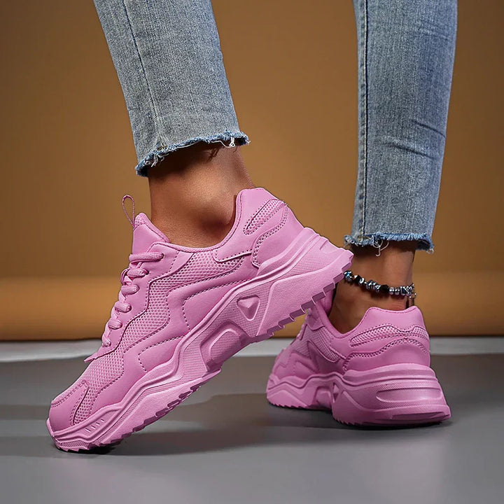 Women’s casual sneakers with mesh upper displayed on a clean plain background.