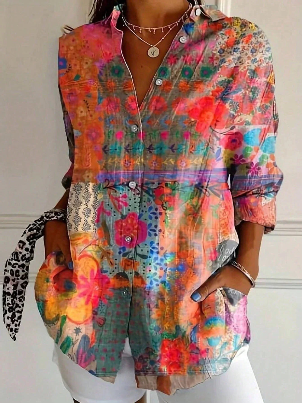 Vibrant printed blouse styled w/ model on a clean background.