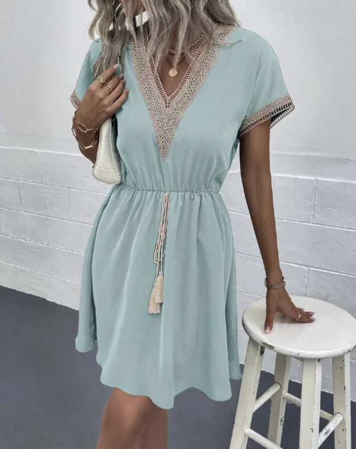 Women’s casual V-neck dress displayed on a plain background with a relaxed boho silhouette.