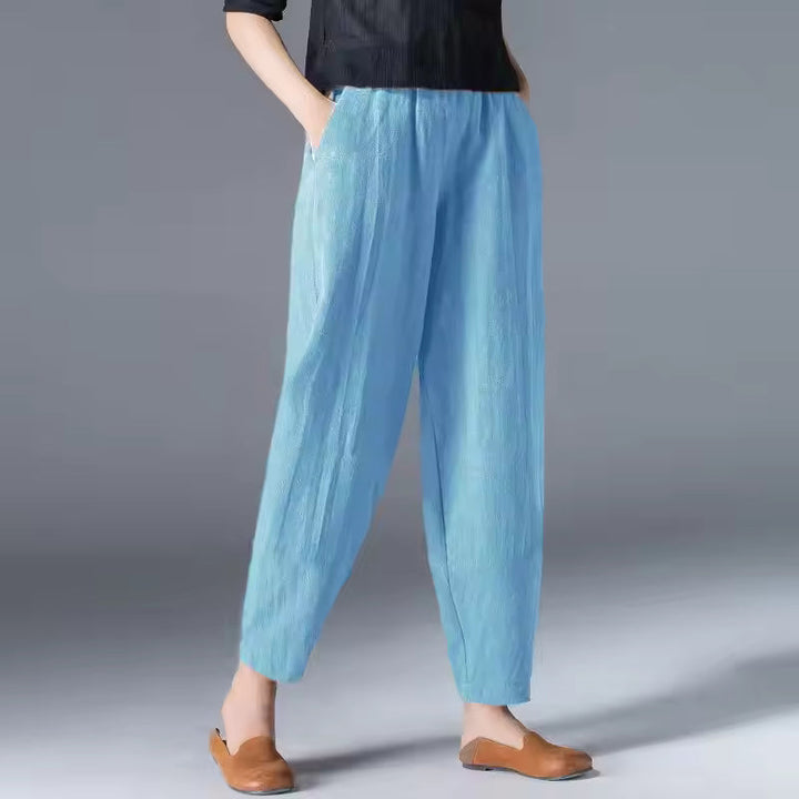 Flowing summer trousers for women displayed on a minimal plain background.