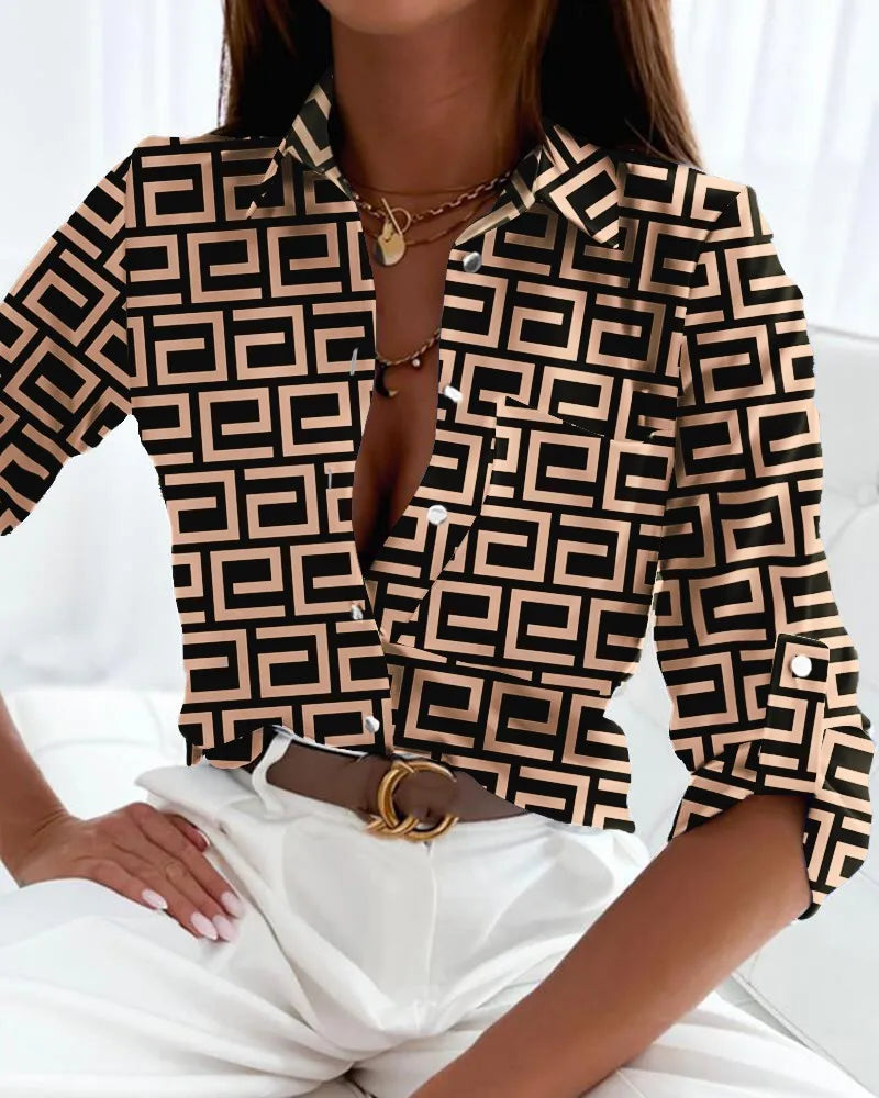 Female model in a silky printed blouse against a clean background.
