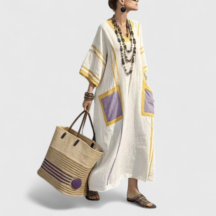 Women’s long summer dress shown on a plain background with soft stripes and embroidered details.