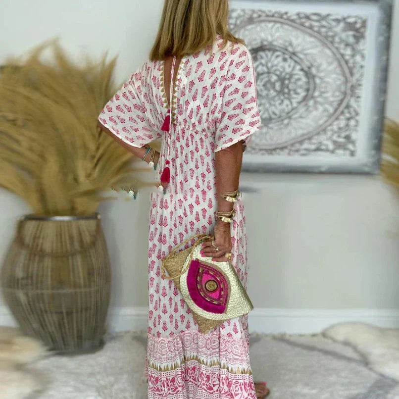 Long boho-inspired maxi dress displayed on a female model with plain background.