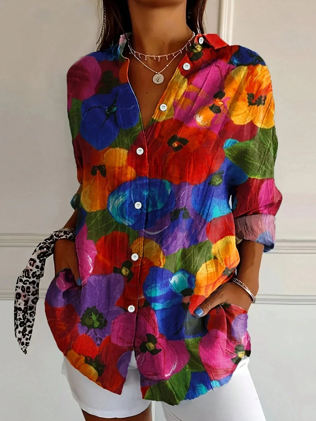 Colourful everyday blouse with flattering silhouette styled w/ model on a clean background.
