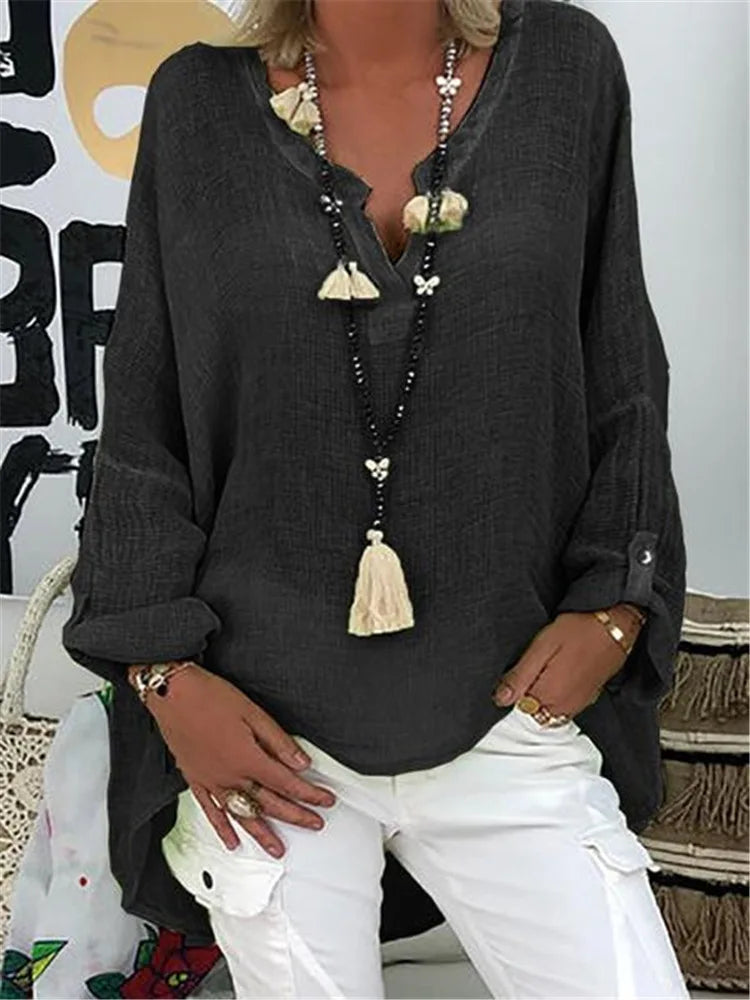 Loose fit stylish blouse featuring a model on a plain background with soft flowing fabric.