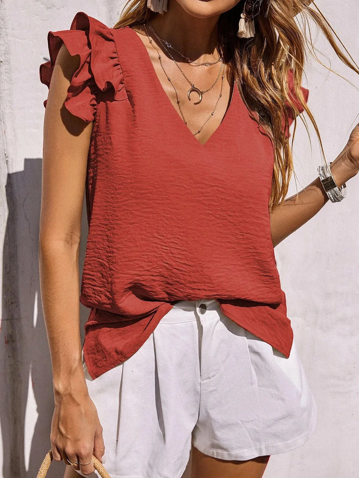 Elegant lightweight blouse with ruffle sleeve detail styled on a model with clean background.