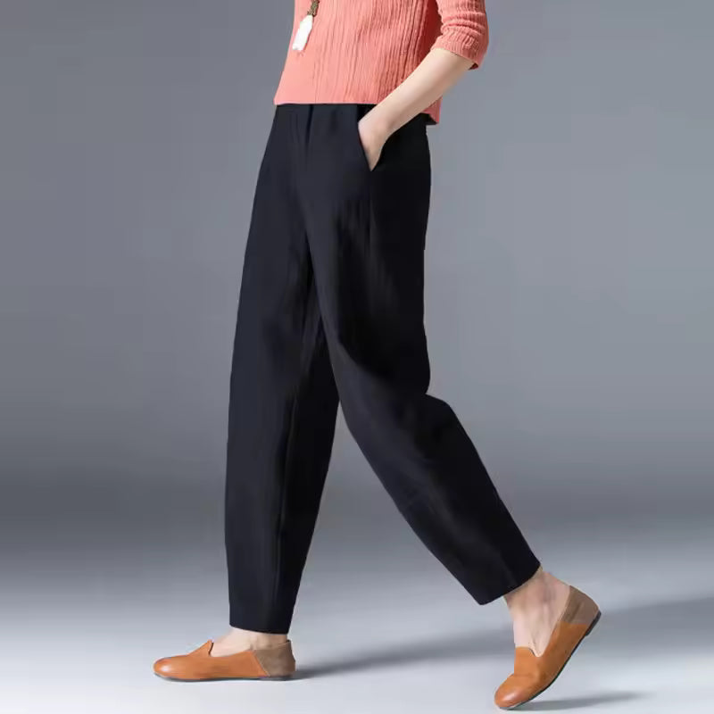 Women’s breathable trousers with a soft flowing silhouette on a plain background.