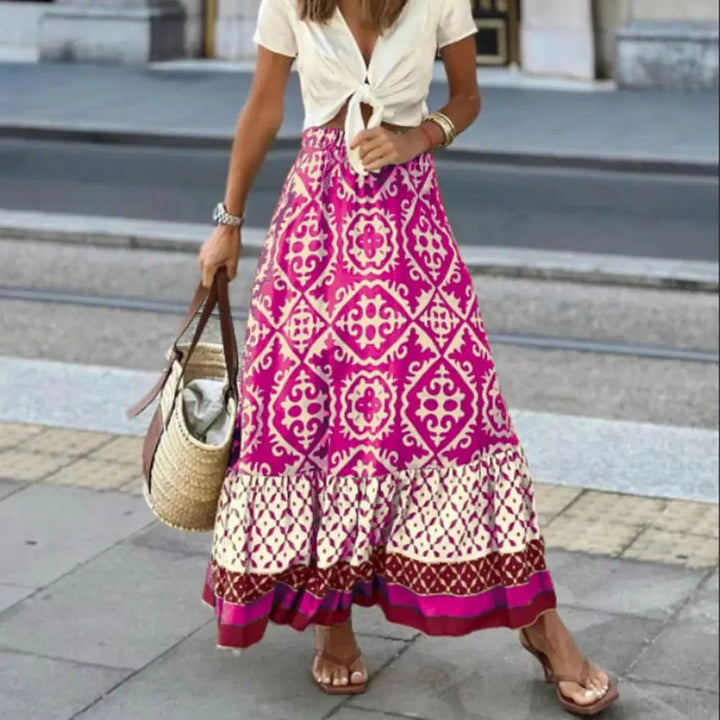 Boho maxi skirt with vibrant tile print on a plain background.