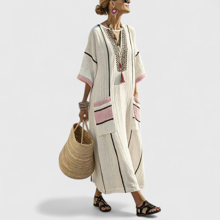 Long striped dress shown on a plain background with teal accents and roomy front pockets.
