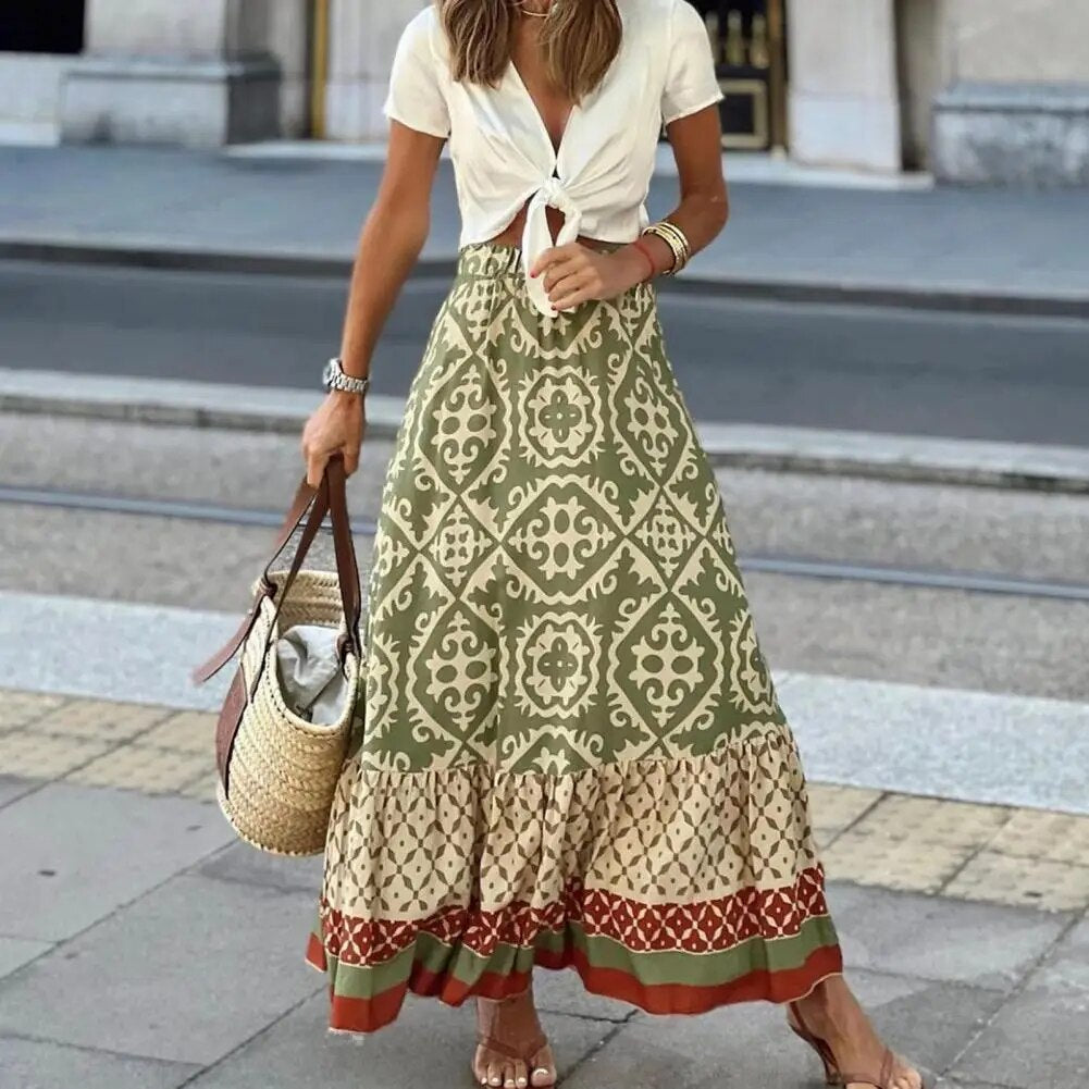 Colourful tile print maxi skirt with tiered ruffle hem on a plain background.
