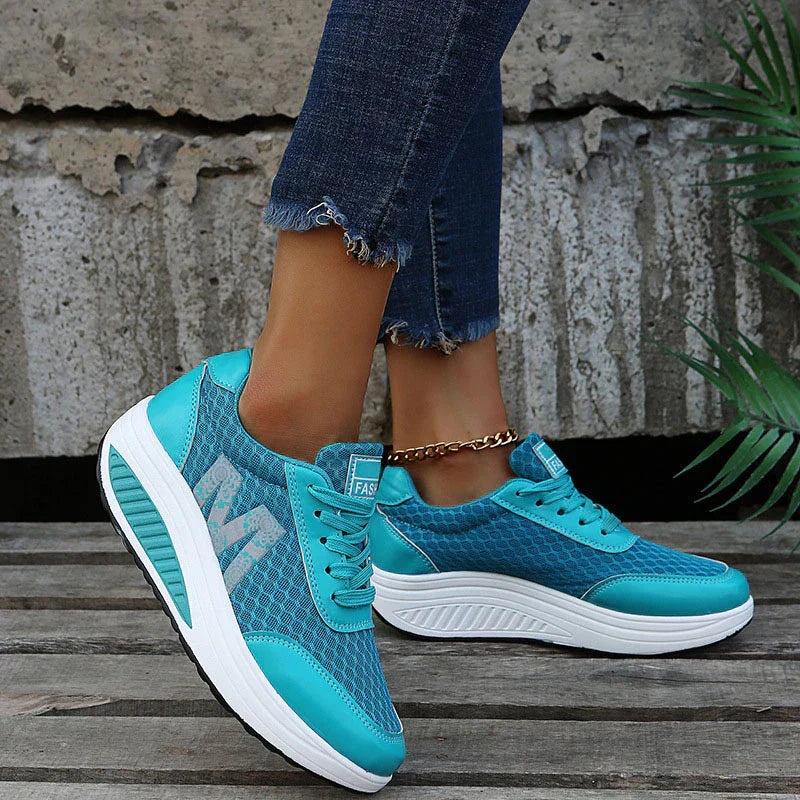 Close-up of feet in comfortable walking shoes against a plain background.