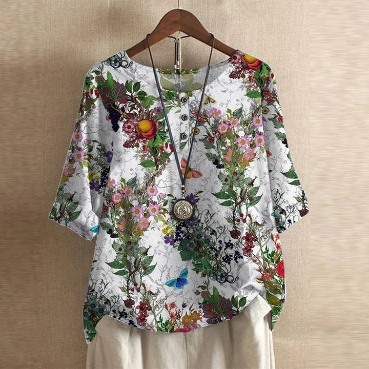 Vintage charm women’s blouse displayed on a plain background with flattering midsection design.