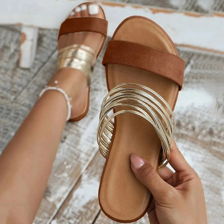 Foot shown wearing lightweight daily sandals on a plain background.