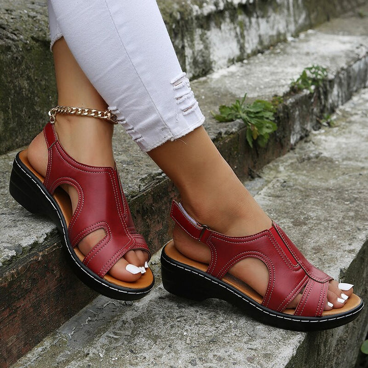 Supportive sandal with adjustable straps shown on foot.