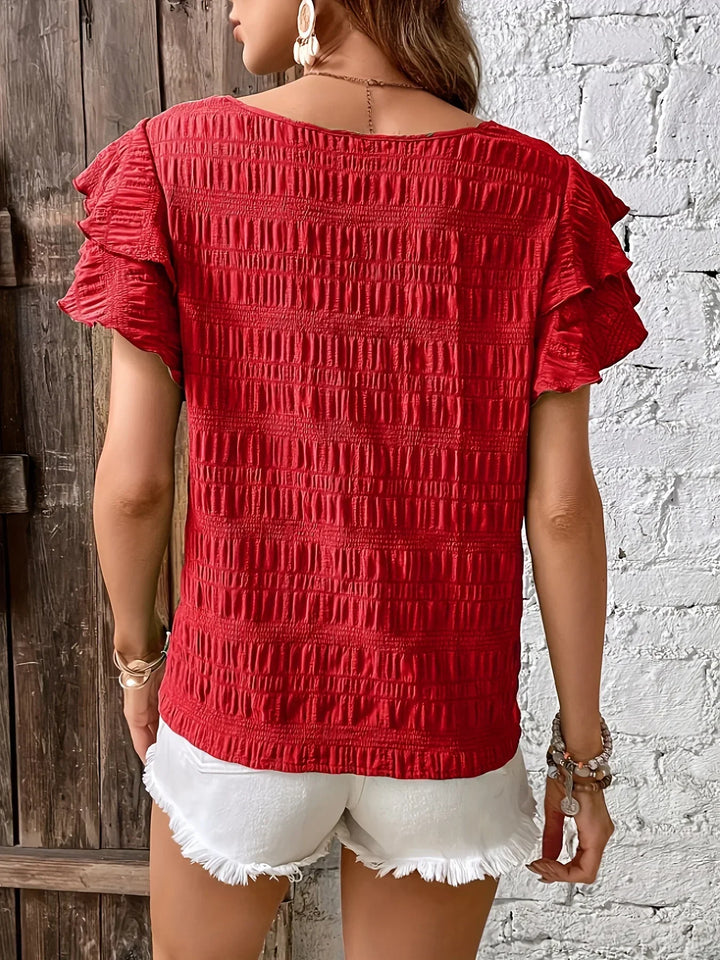 Model showcasing a light feminine blouse on a clean background and back angle view