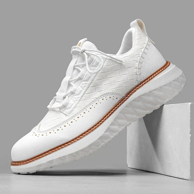Casual lace-up sneakers shown on feet with a clean plain backdrop.
