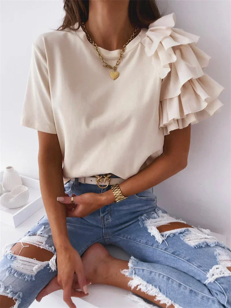Soft lightweight blouse with statement ruffle sleeves on a clean background.