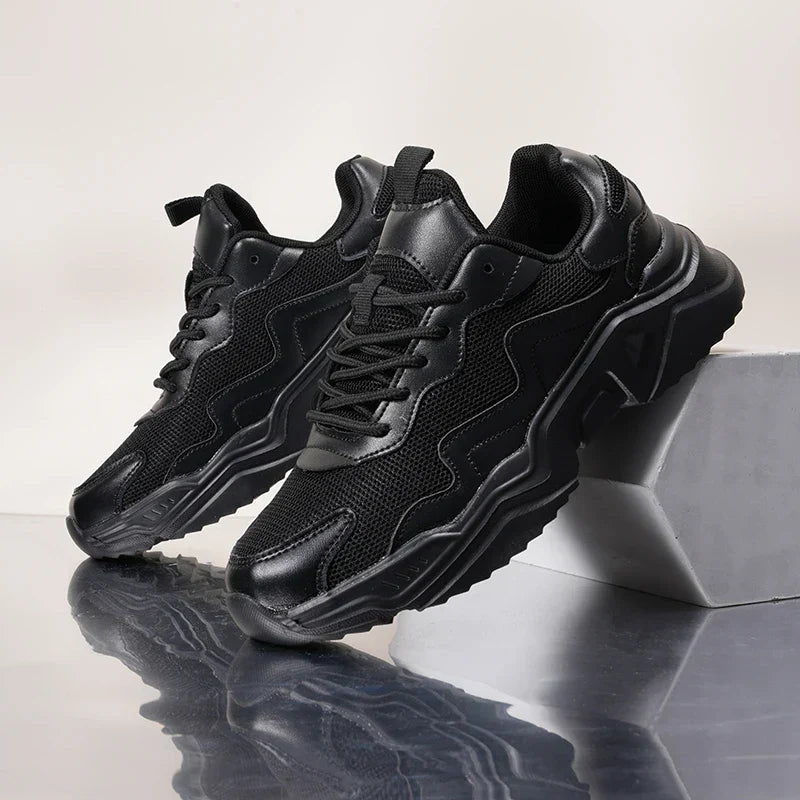 Female model showcasing lightweight mesh sneakers on a plain studio background.
