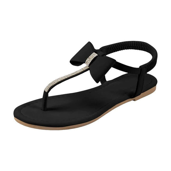 Bow sandals on a clean plain backdrop.
