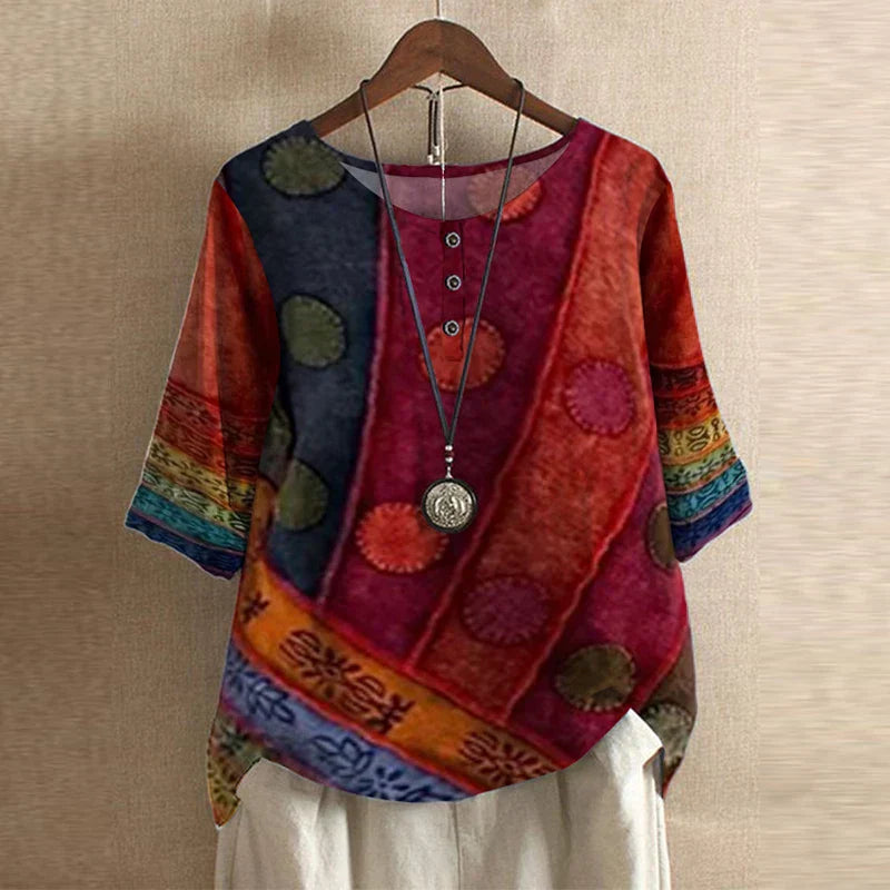 Elegant retro blouse displayed on a plain background with flattering waist shaping and modest coverage.