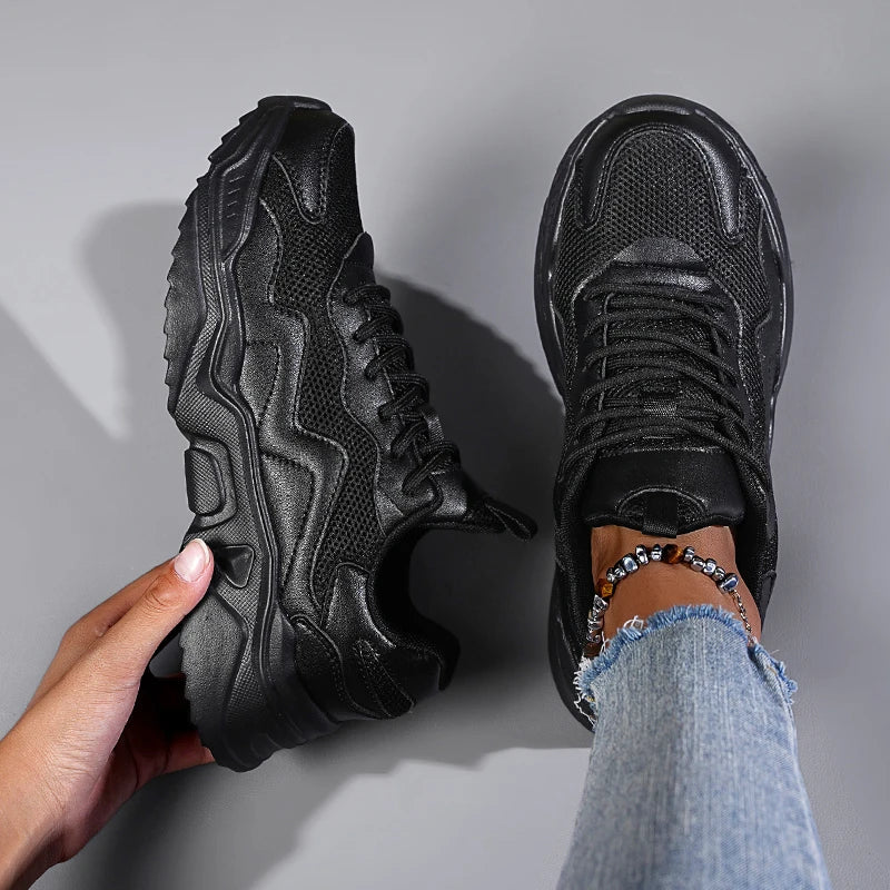 Lightweight women’s sneakers shown on a plain background with a sporty design.