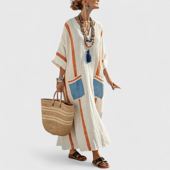 Striped summer dress on a plain background featuring 3/4 sleeves and a loose flowing shape.
