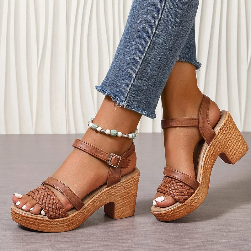 Woman standing in woven platform sandals with feet only on clean background.