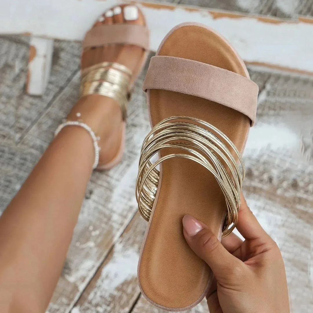 Slip-on sandals with cushioned footbed shown on foot.