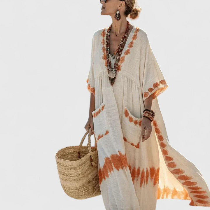 Women’s casual maxi dress displayed on a plain background with embroidered neckline and pocket details.