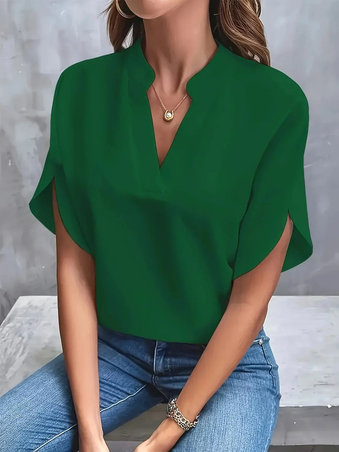Chic blouse presented with a model on a clean background showing a structured fit.