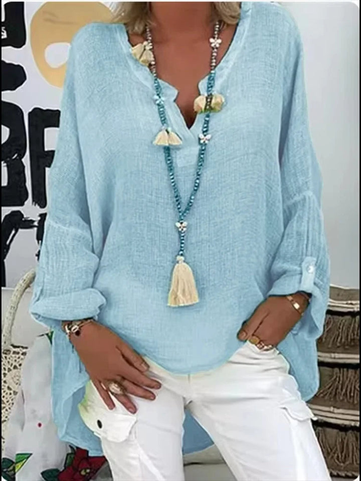 Oversized flowy blouse featuring a model on a plain background showcasing relaxed elegance.
