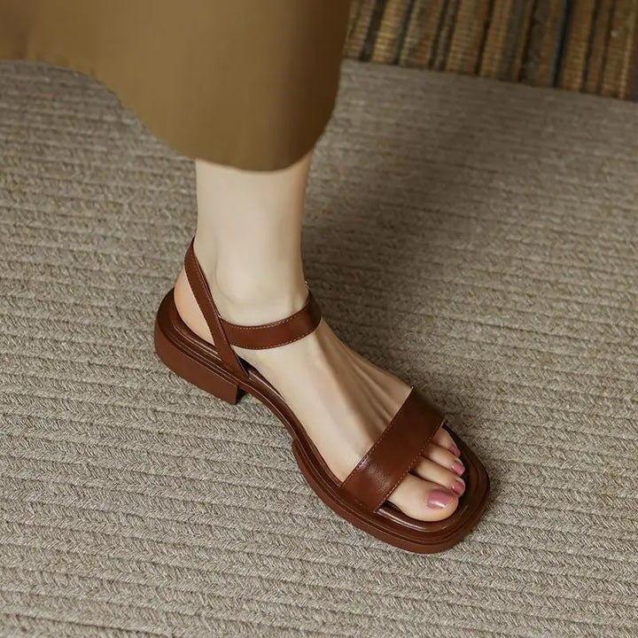 Minimalist women’s sandal with clean lines displayed on a plain background.