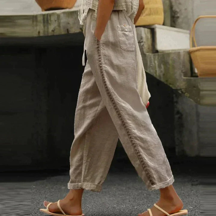 Female model in neutral wide-leg trousers