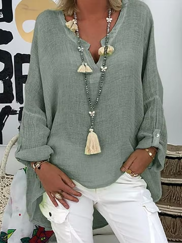 Casual chic oversized blouse featuring a model on a plain background with flattering flow.