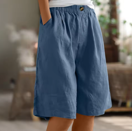 Female model showcasing breathable summer shorts on a clean background.
