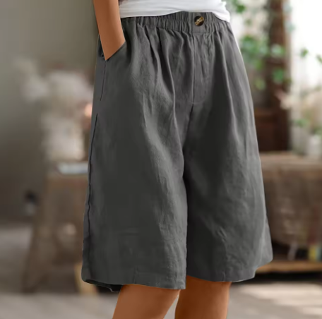 Woman modeling lightweight casual shorts with a smooth waistband on a clean background.