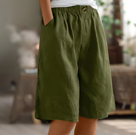 Female model wearing relaxed women’s comfort shorts on a plain background