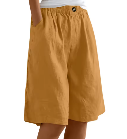 Female model wearing relaxed-fit shorts with smooth waist detail on a plain background.