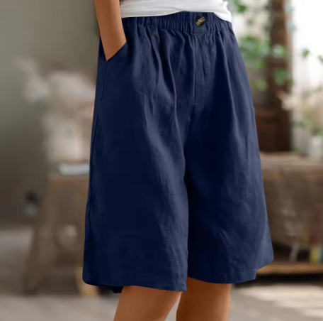 Model wearing loose casual women’s shorts with a flattering drape on a clean background.