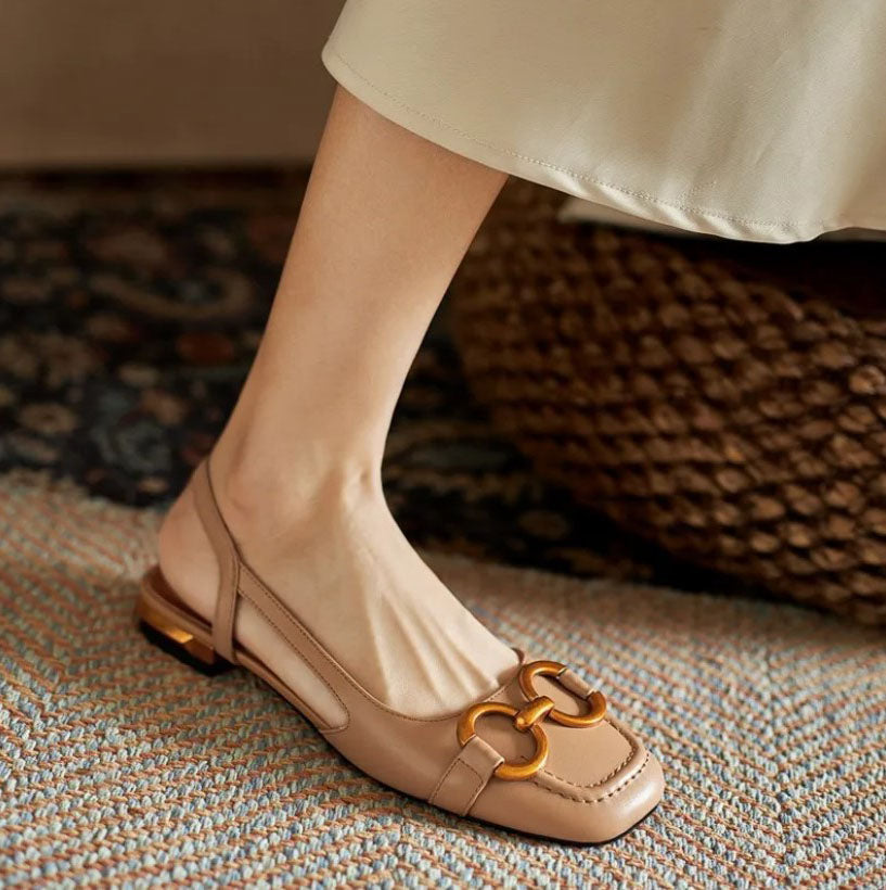 Adjustable buckle women’s sandal shown on foot in a clean studio setting.