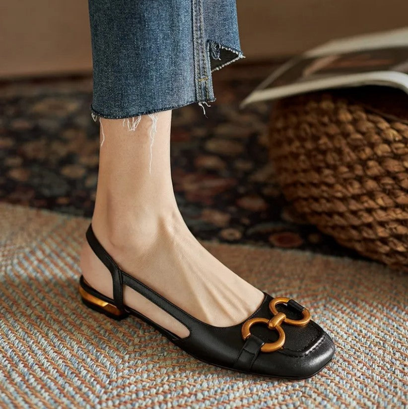 Stylish women’s comfort sandal with stitched details on a plain background.