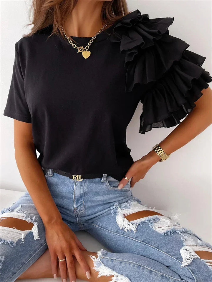 Chic ruffle sleeve blouse displayed on a plain background with soft draped shaping.