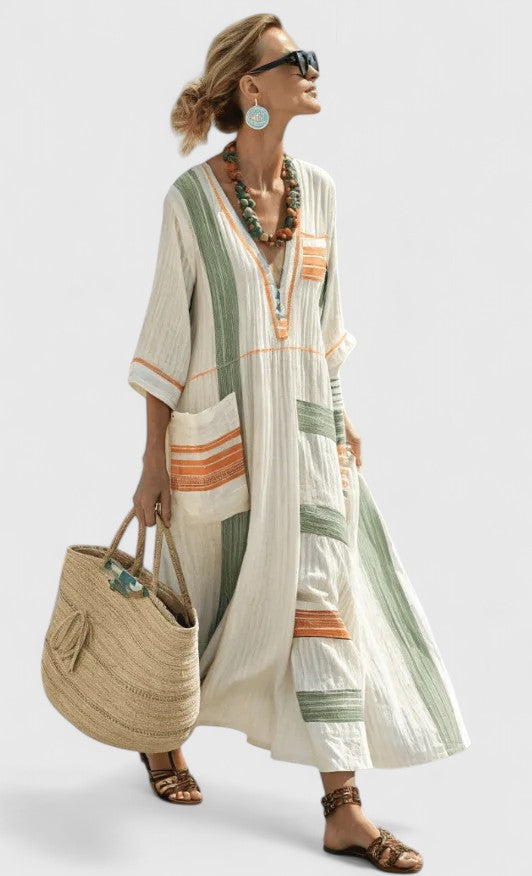  Woman in a striped boho-style maxi dress with a roomy shape on a plain background.