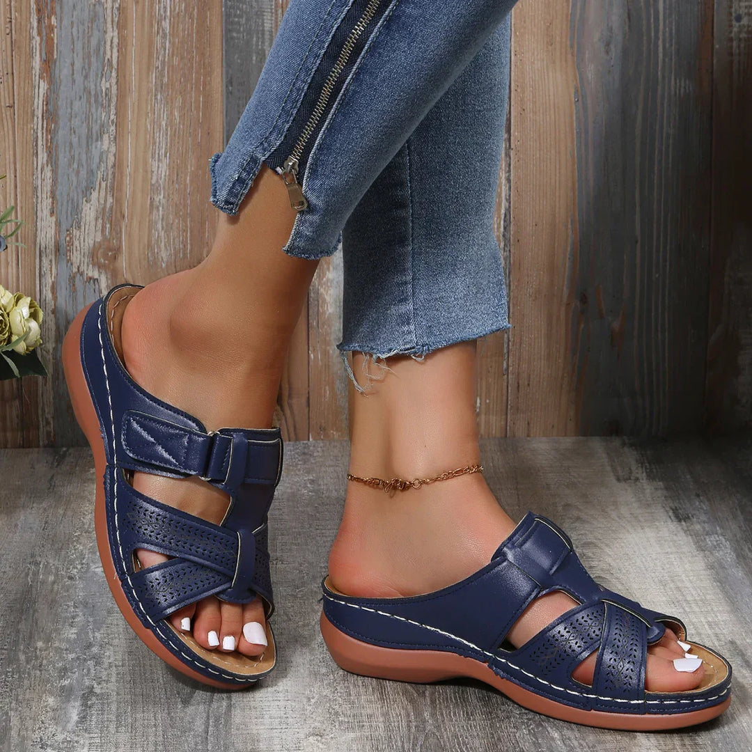 Female model showcasing cushioned wedge sandals for everyday outfits.