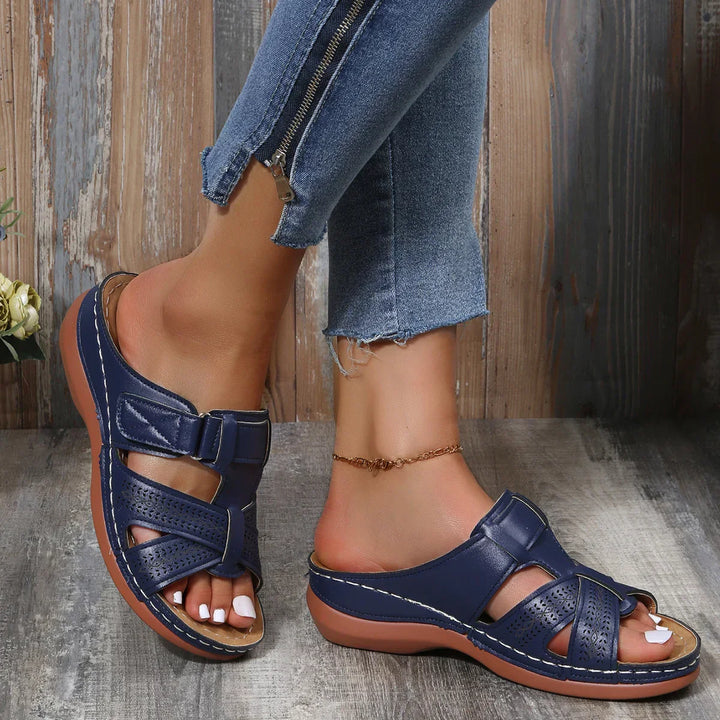 Female model showcasing cushioned wedge sandals for everyday outfits.
