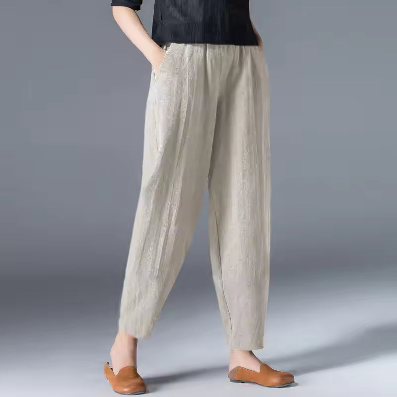 Women’s lightweight summer trousers on a plain background with a relaxed flowing leg.