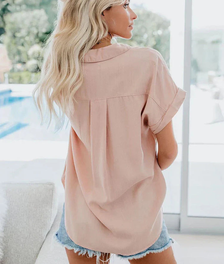 Woman in a lightweight relaxed blouse styled for everyday comfort on a plain background, back view